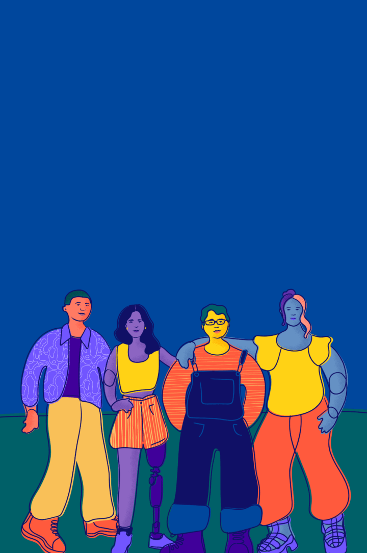 Four young people stand and smile.