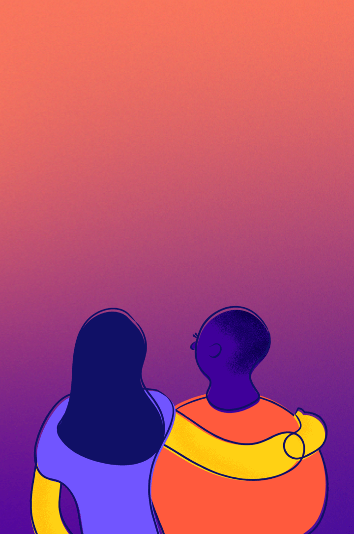 Two young people put arms on each other's shoulders and look out at the horizon.