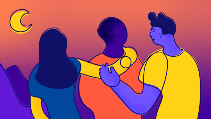 Three smiling young people put arms on each other's shoulders and look out at the moon over a mountainous landscape.