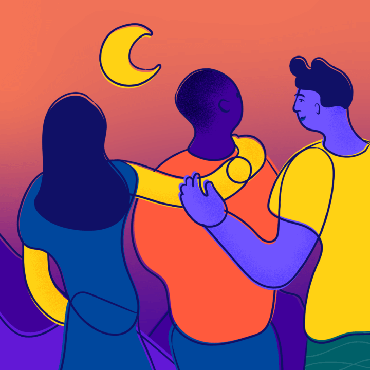 Three smiling young people put arms on each other's shoulders and look out at the moon over a mountainous landscape.