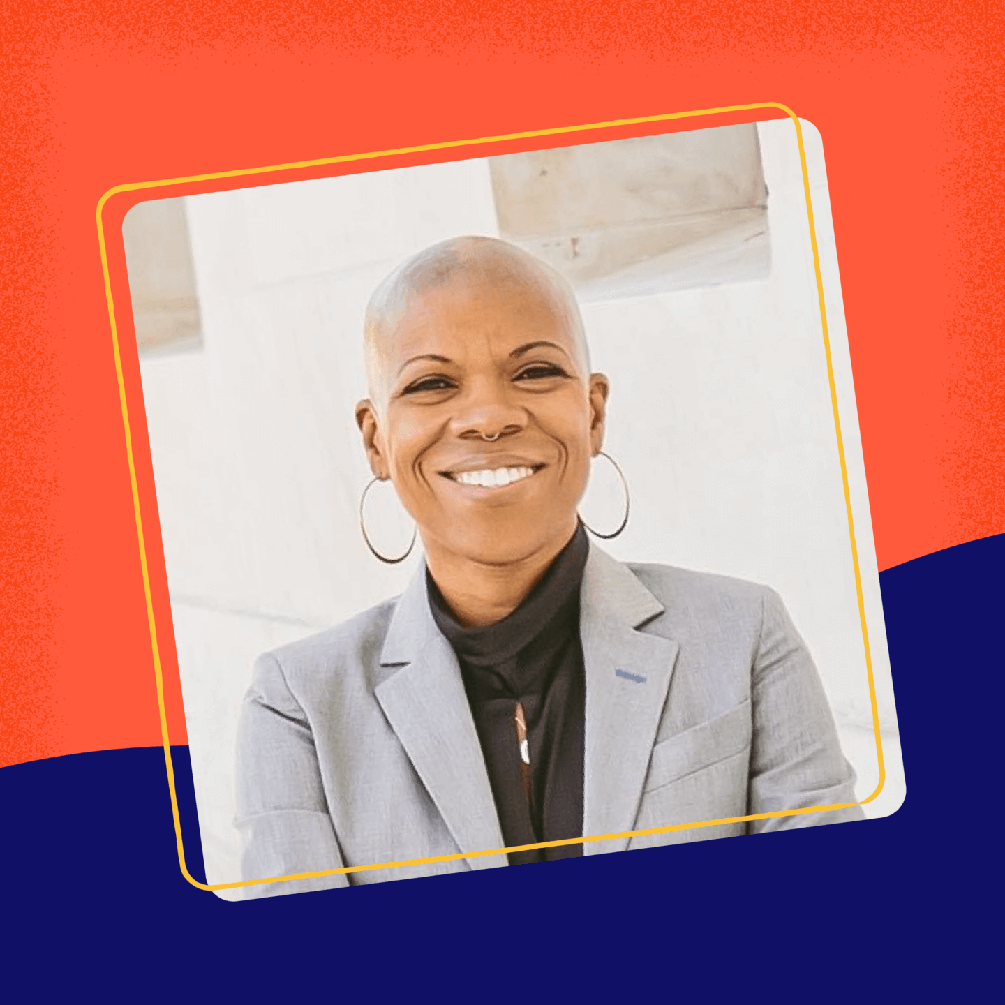 Picture of Jaymes Black posing with Grey Jacket with a blurred background.